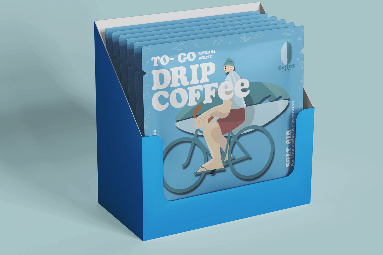 Display box of Sands Coffee To-Go drip bags with the Salt Air cyclist illustration